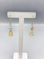 A pair of earrings with citrine quartz yellow and gray drops.