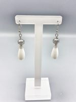 A stand exhibiting DROP WHITE AGATE EARRINGS.