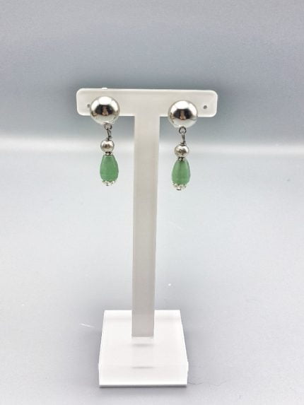 A pair of earrings CLIP-ON EARRINGS WITH GREEN AVENTURINE on a stand.