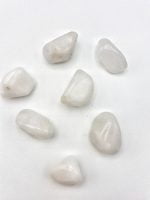 Group of White Jade Stones Tumbled on Jade top.