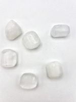 Five pieces of TUMBLED SELENITE on a white surface.