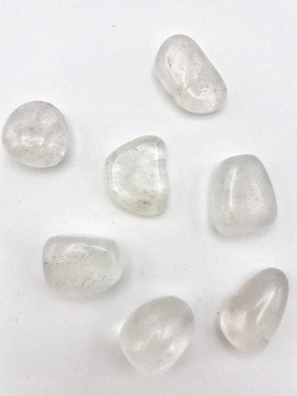 Group of stones TUMBLED ROCK CRYSTAL on a white background.