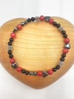 A CORAL, HEMATITE AND BLACK ONYX BRACELET with black and red beads.