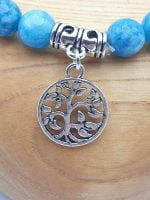 A BRACELET OF ANGELITE AND TREE OF LIFE with Tree of Life charm.