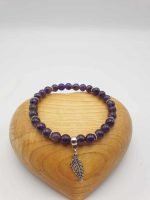 An AMETHYST BRACELET WITH A SILVER LEAF SPELL.