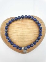 The product is a lapis lazuli bracelet with a silver pendant in the shape of a hamsa.