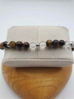 A MEN'S BRACELET WITH ROCK CRYSTAL, TIGER'S EYE AND LION PENDANT with crystal accents.