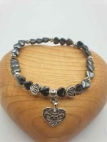A HEMATITE HEART SHAPED BRACELET THAT GIVES STRENGTH AND VITALITY TO INCREASE THE WILL TO LIVE that provides strength and vitality to increase the will to live.