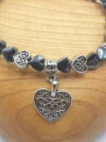 A HEMATITE HEART-SHAPED BRACELET THAT GIVES STRENGTH AND VITALITY TO INCREASE THE WILL TO LIVE bracelet that enhances vitality and the will to live.