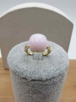 GOLDEN RING WITH PINK CRYSTAL MM 13, resting on a box.
