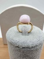 A 13 MM PINK CRYSTAL GOLD RING with a pink crystal placed on top of a box.