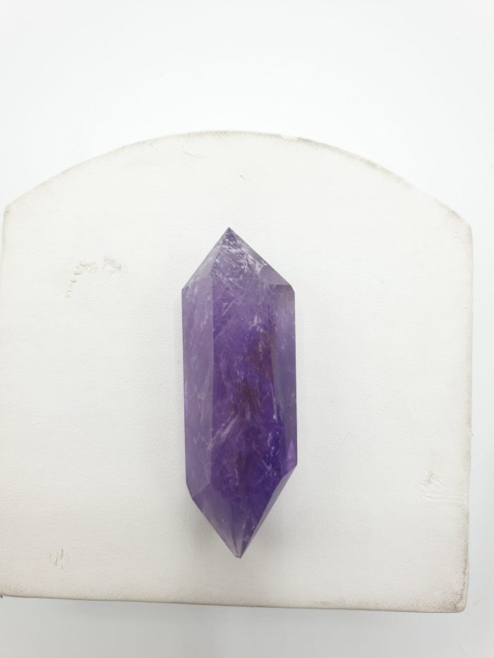 Biterminated amethyst tips placed on a white table.