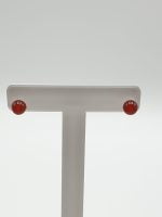 A white handle with red buttons, made of RED CARNELIAN EARRINGS IN STERLING SILVER.