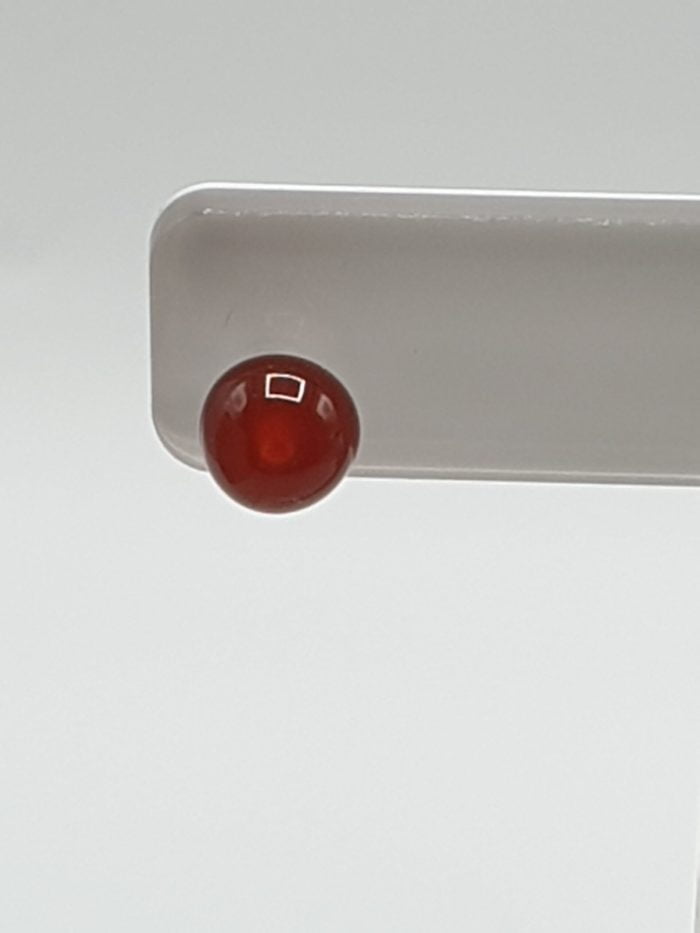 An earring RED CARNELIAN EARRINGS IN SILVER on a white background.