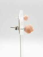 A pair of earrings PINK CORAL EARRINGS IN THE SHAPE OF A SILVER FLOWER on a silver support.