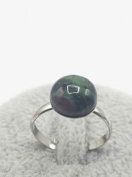 A ring with a round ruby zoisite and purple.