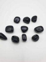 Group of stones BLACK ONYX TUMBLED on a white background.