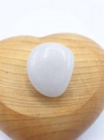 A white stone TUMBLED WHITE ONYX on a tumbled wooden heart.