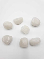 A bunch of pebbles of TUMBLED WHITE ONYX on a tumbled surface.