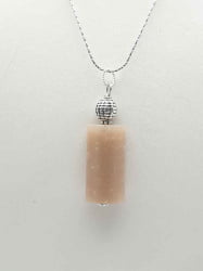 The SUNSTONE PENDANT PENDANT is on a silver chain.