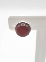 A white table with RED CARNELIAN CLIP EARRINGS.