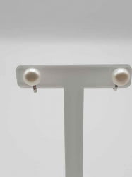 A pair of CLIP EARRINGS WITH PEARLS white on a white stand.