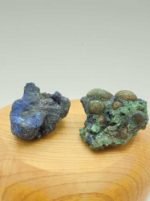 Due minerali AZZURRITE MALACHITE GREZZA sopra una superficie di legno.