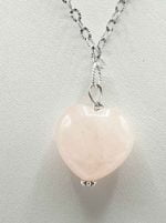 The ROSE HEART QUARTZ PENDANT is on a silver chain.