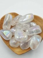 A heart-shaped bowl filled with quartz crystals AURA ANGELI TUMBLED QUARTZ.