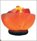 A red BRAZIER SALT LAMP with a candle inside.
