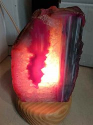 A GEODE AGATE LAMP 2/3 KG resting on a wooden base.