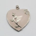 A heart-shaped pendant with rose quartz and plated brass bezels.