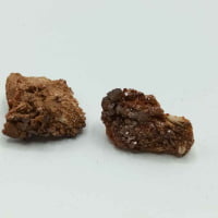 Two pieces of RAW VANADINITE chocolate on a raw white background.