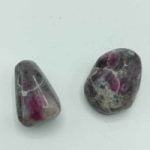 Pair of RUBY BURATTATO FELDSPARE gemstones in tumbled style on a white surface.
