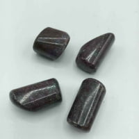 Set of four cabochons RUBY KYANITE TUMBLED on white surface.