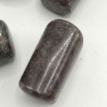 Group of purple CYANITE RUBY stone beads on a white TUMBLED background.